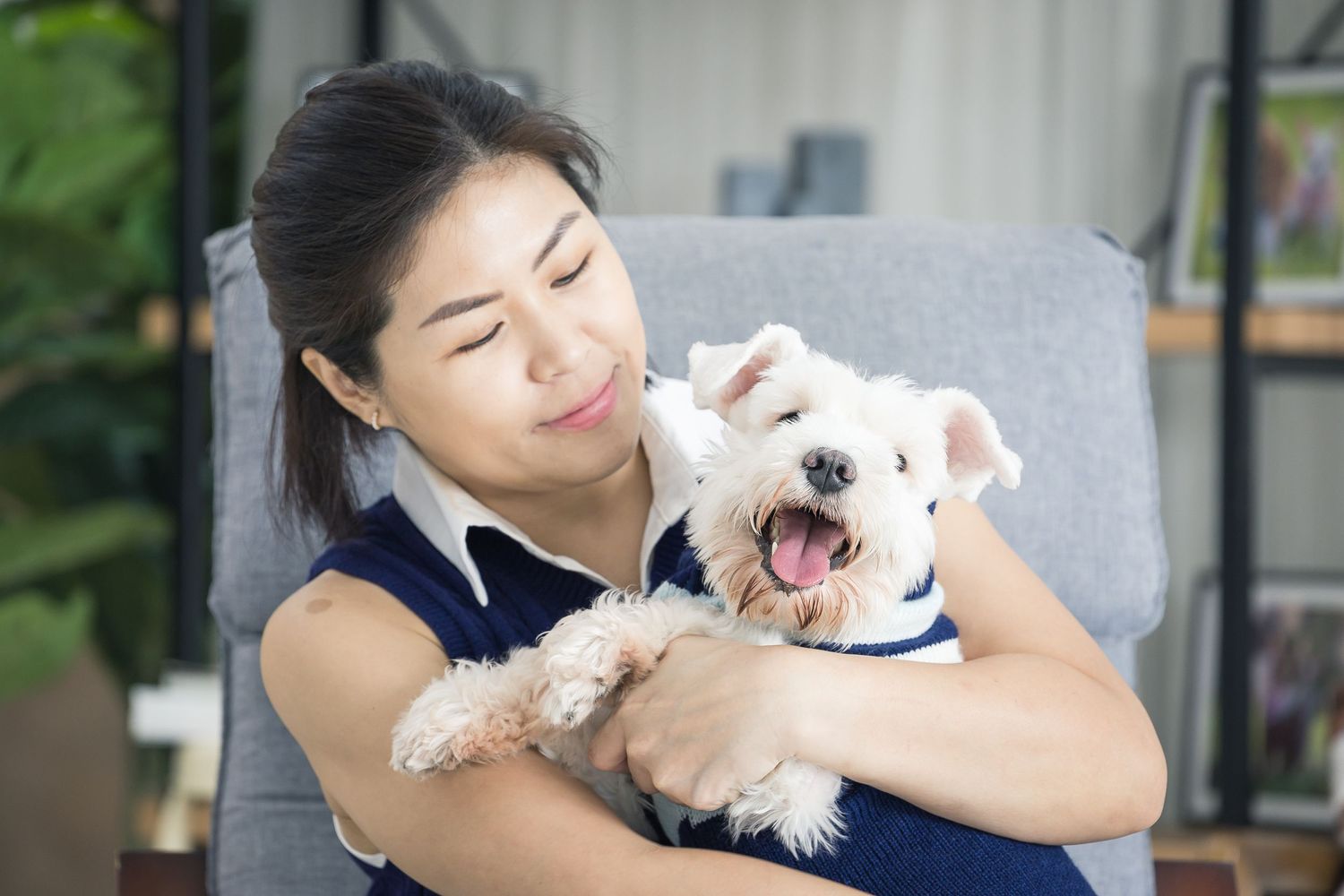 photo of a lady hugging her white dog