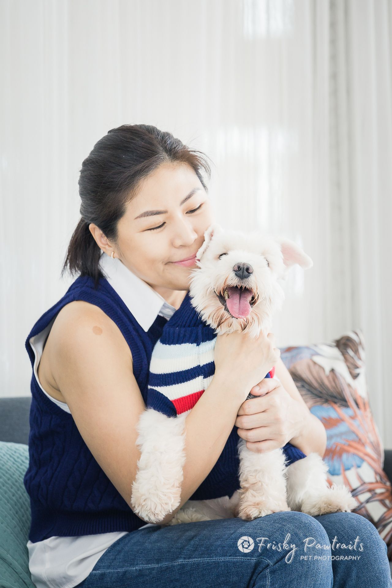 a lady cuddling her dog in the living room