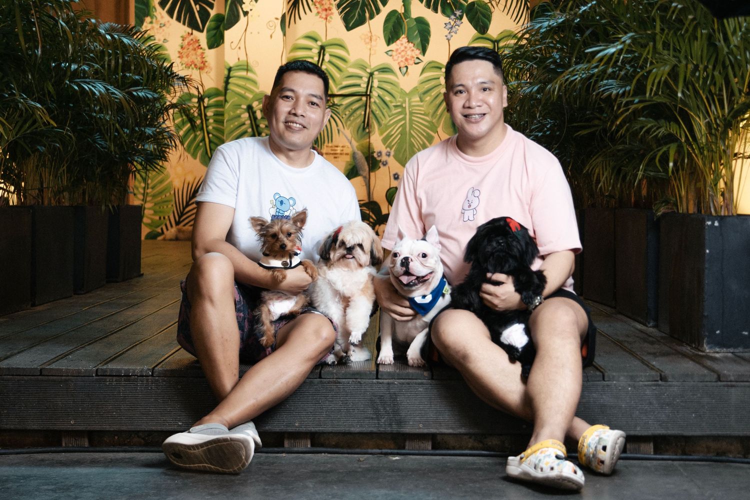 outdoor portrait of a human couple with their dogs