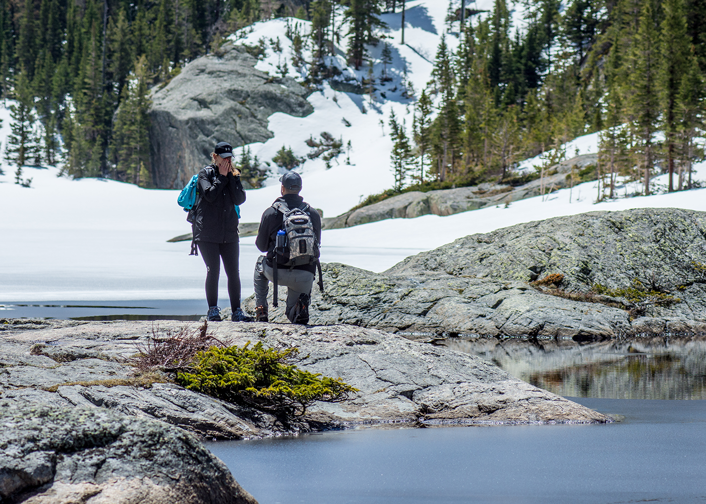 Woman complete surprised by his marriage proposal at Mills Lake inside Rocky Mountain National Park.