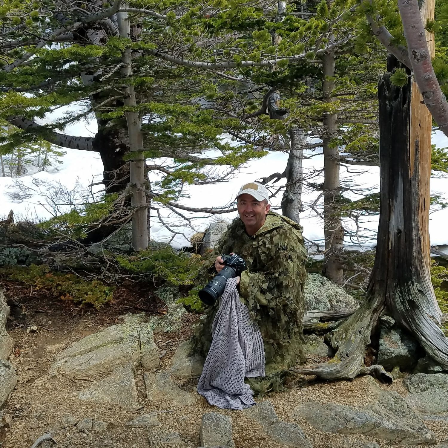 Hidden photographer wearing ghillie suite after a hidden marriage proposal session in Colorado Rocky Mountain National Park