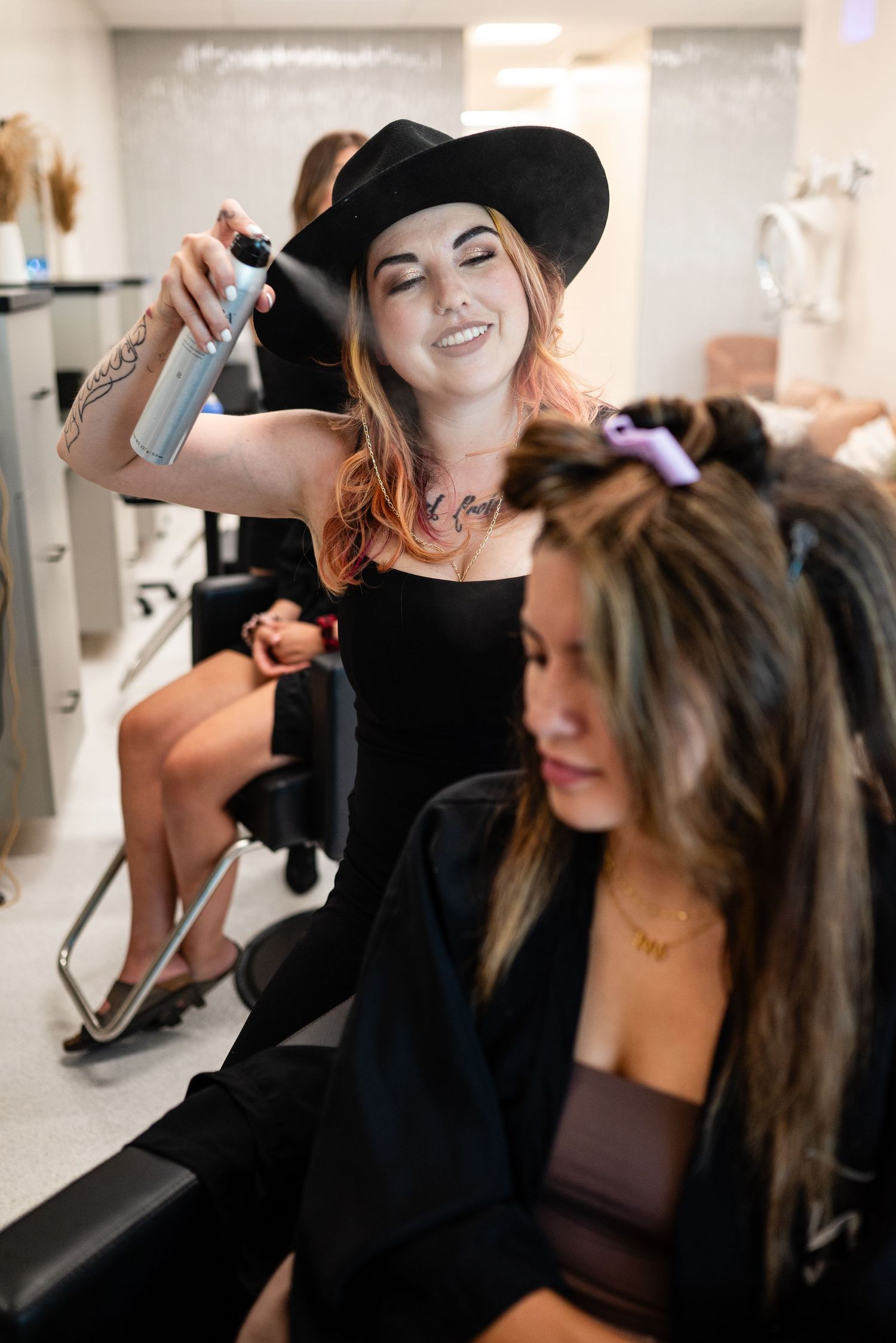 A hair styling session in progress at a modern salon with professional equipment.