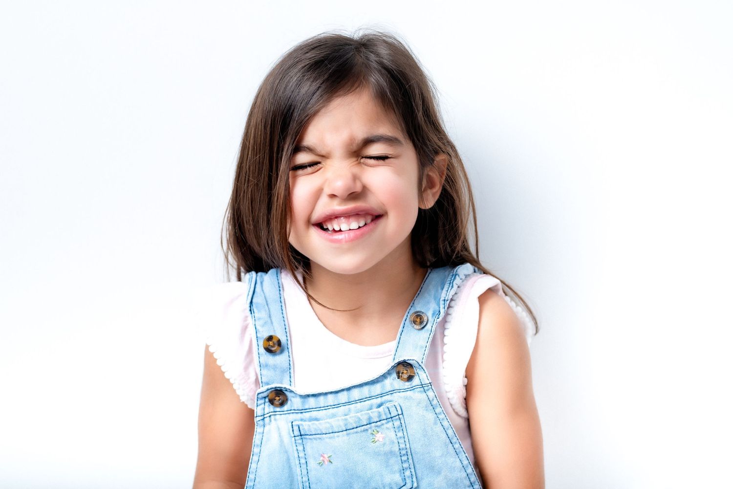 Child laughing during in-studio kids mini session, captured without direction