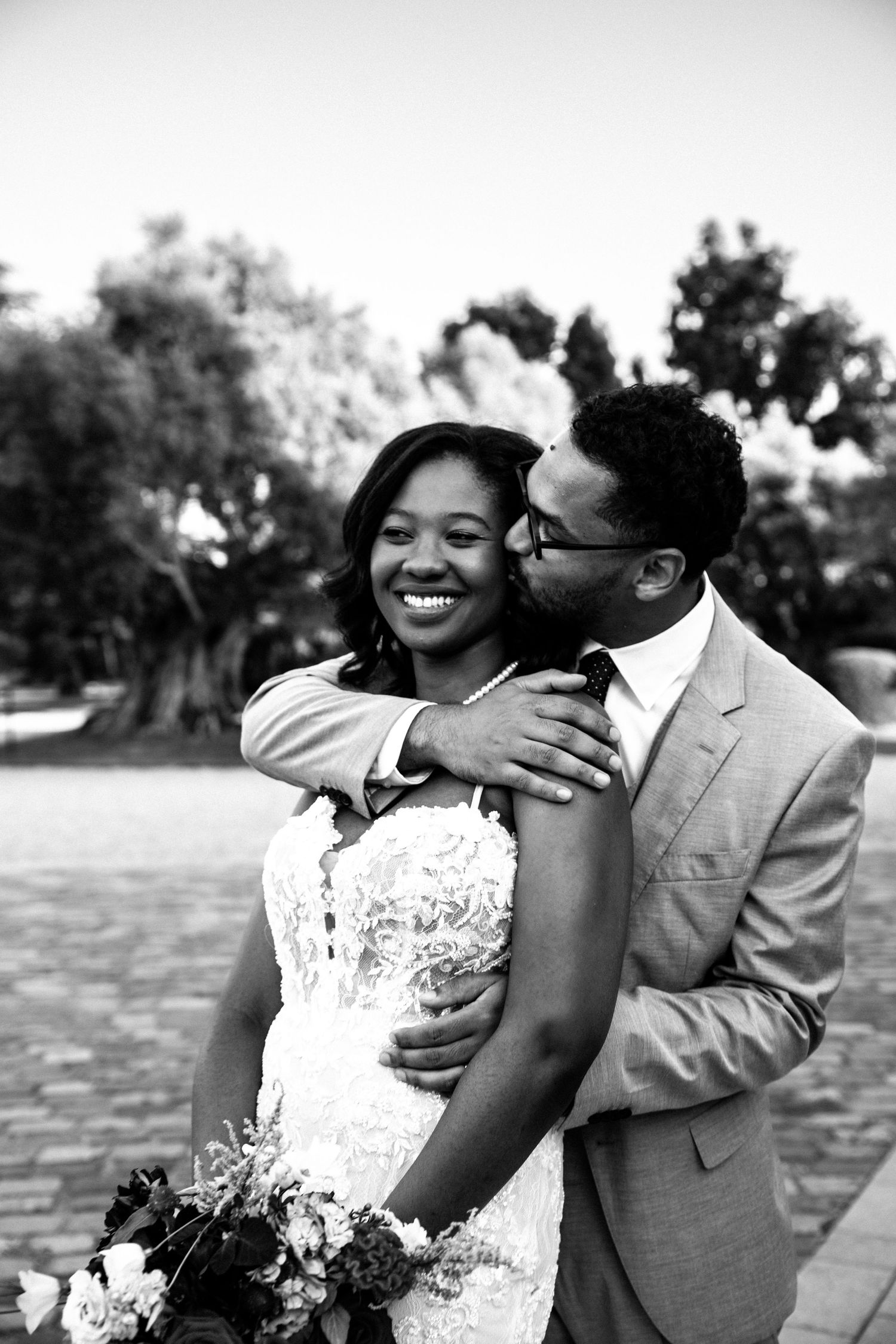 A joyful wedding moment captured in black and white photography.