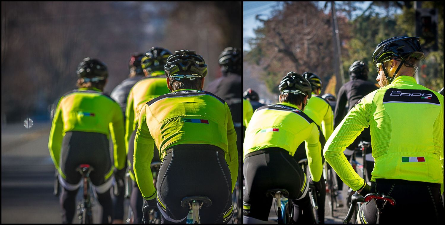 Cyclists wearing high-visibility yellow jerseys ride in formation on a group training ride.