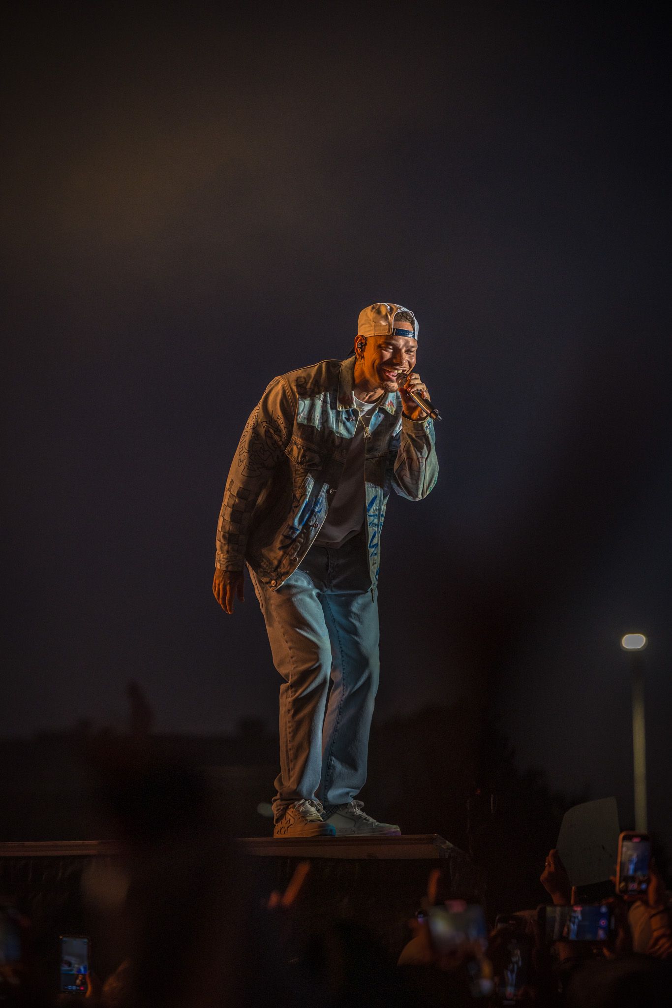 A sequence showing a performer on stage moving in dramatic poses against a dark nighttime backdrop.