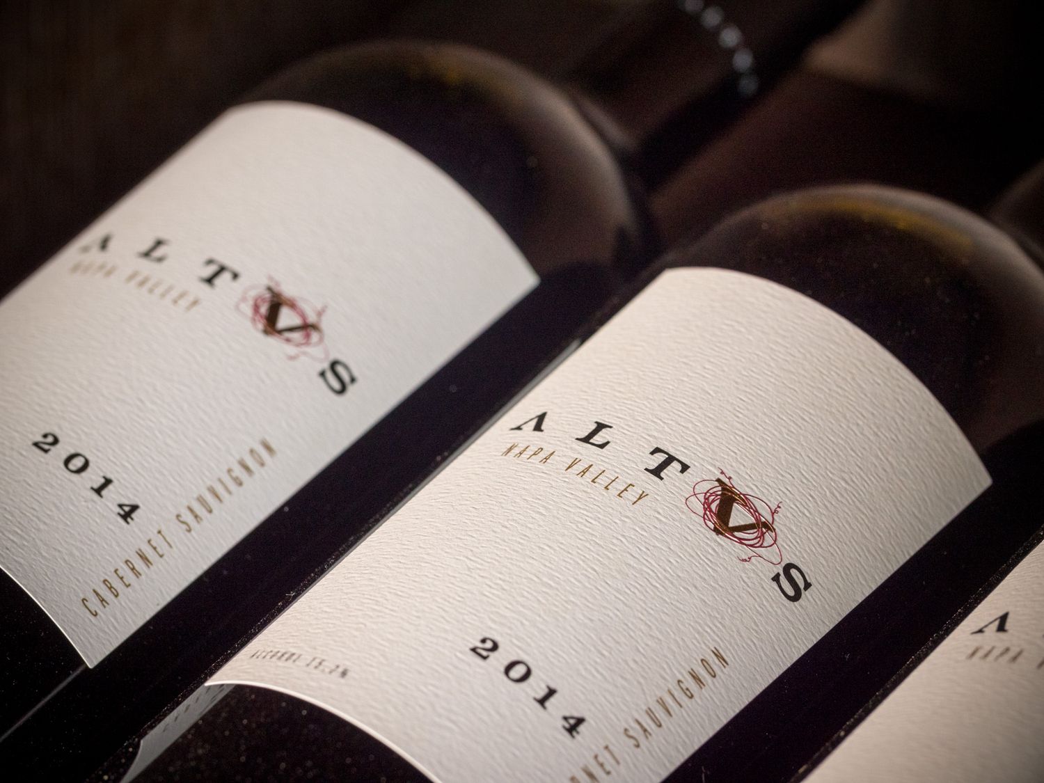 Close-up of Altus wine bottles from 2014 vintage showing labels.