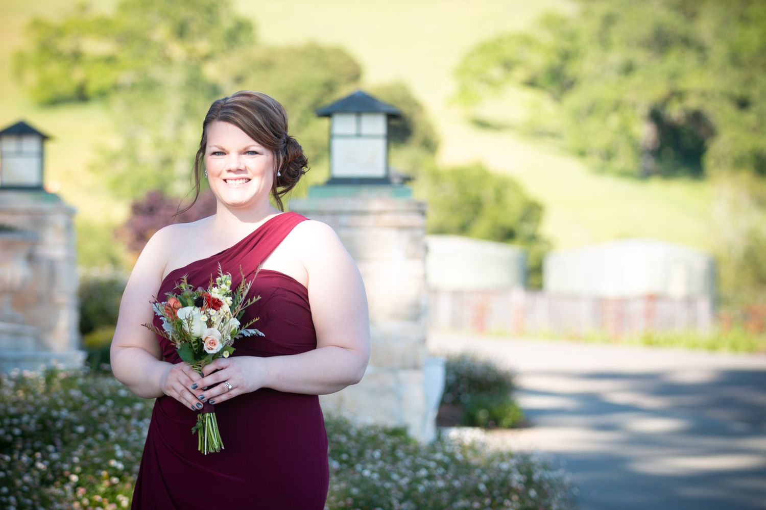 Beautiful outdoor wedding at winery with couple and officiant during ceremony.