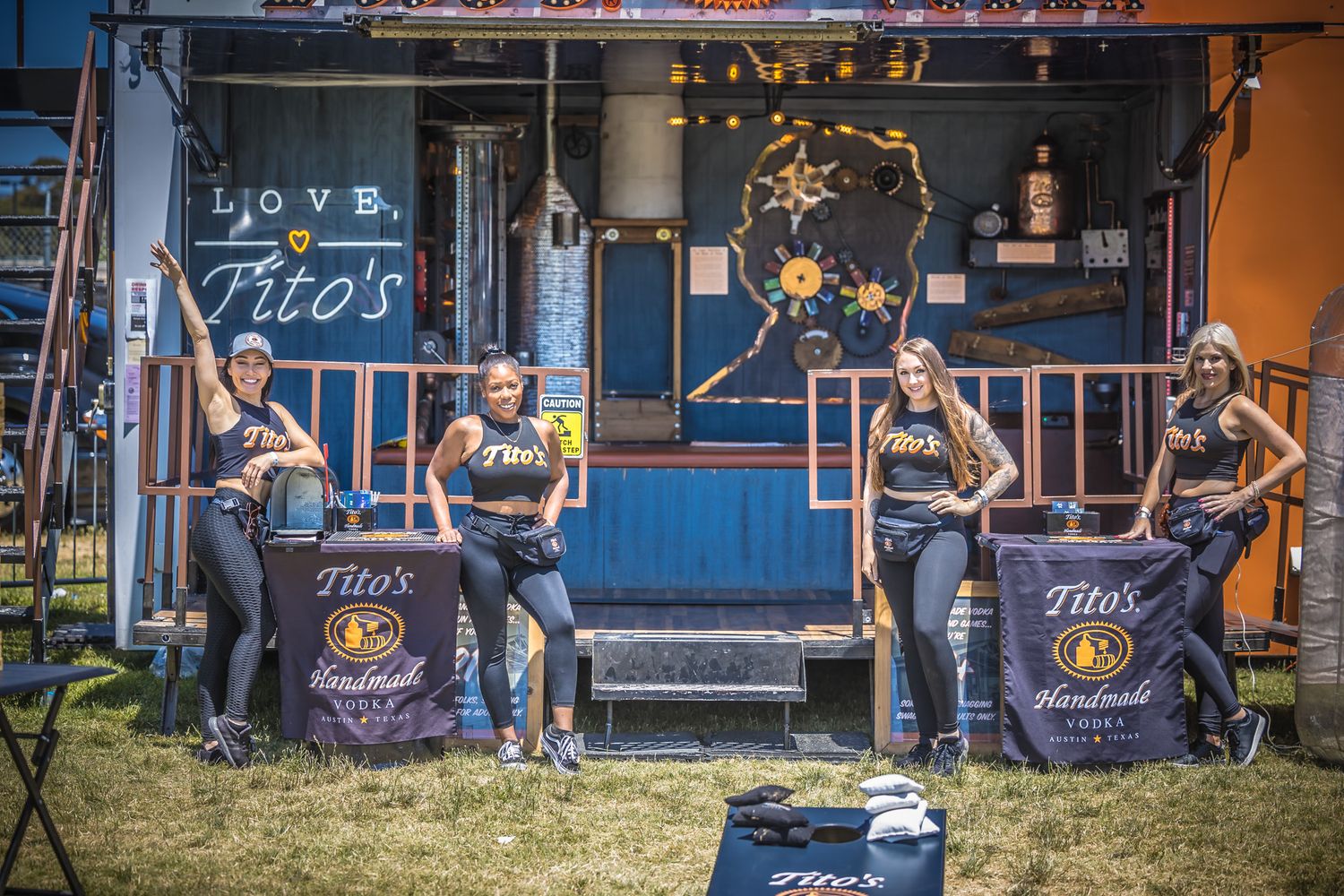 Outdoor festival booth setup with staff in matching uniforms.