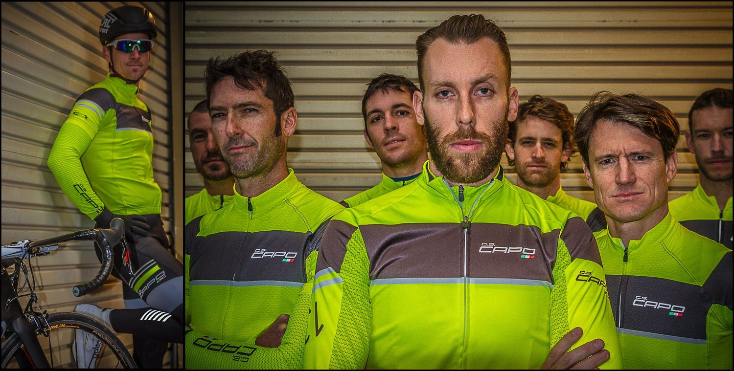 Professional cycling team wearing fluorescent yellow uniforms lined up for official photo.