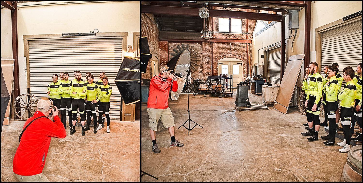 Cycling team members in high-visibility gear gather for indoor training session.