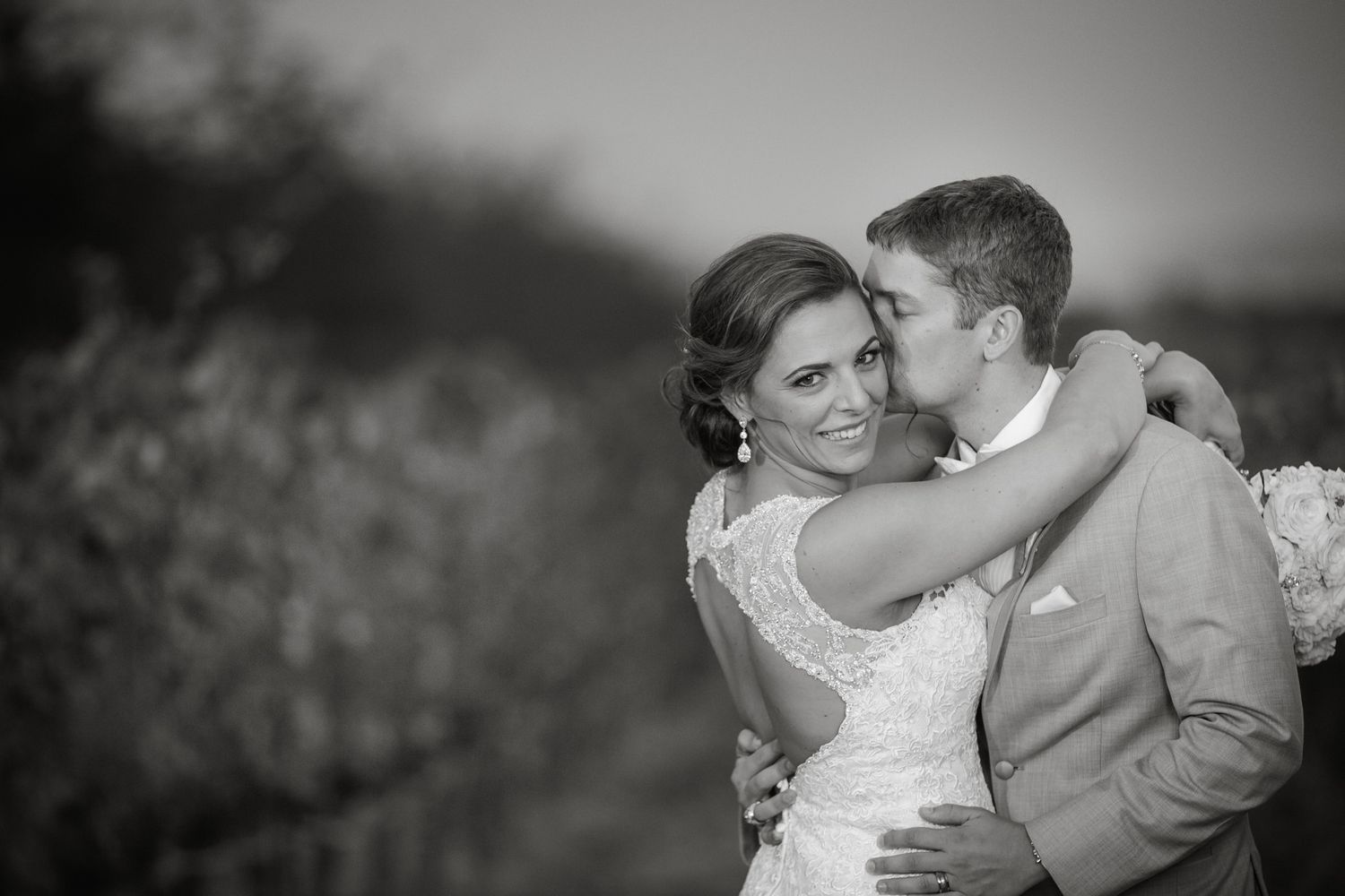 Black and white wedding photos show romantic moments between bride and groom during their celebration.