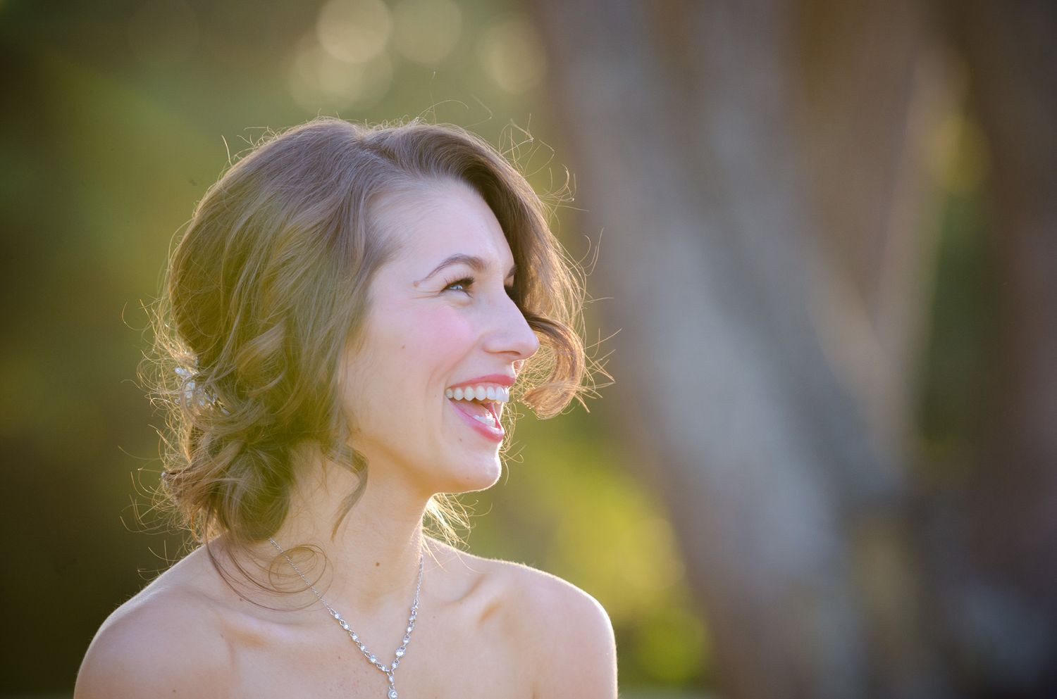 A joyful candid portrait with bokeh lighting effect during golden hour.