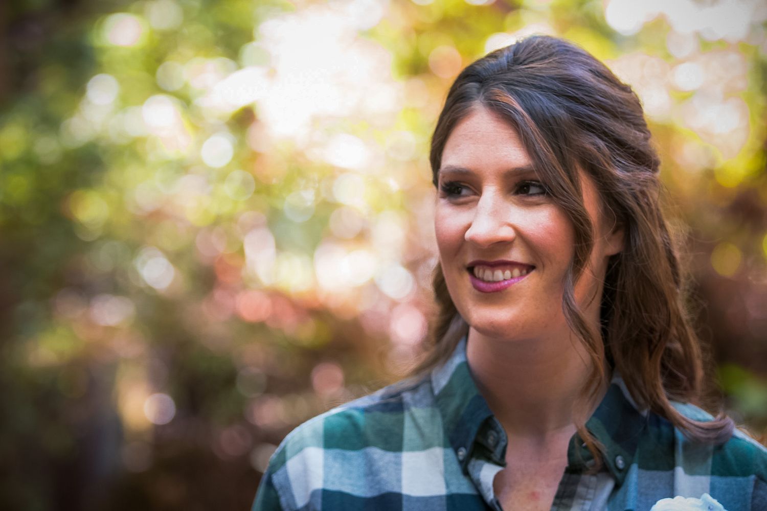 Candid outdoor photo session in natural sunlight with plaid clothing.