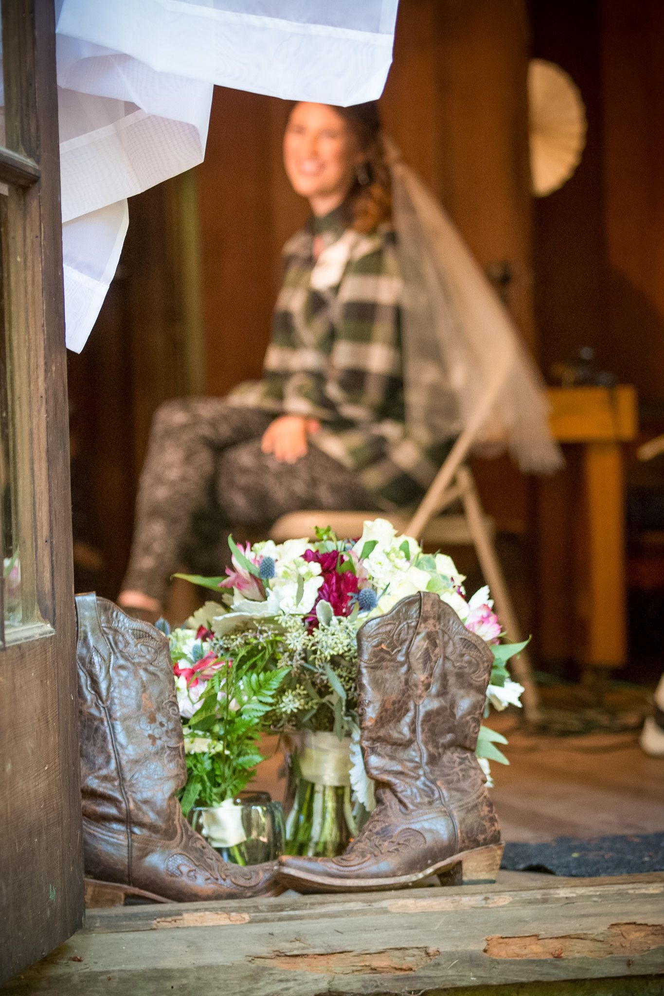 Mason jars with floral arrangements and rustic decor on wooden surface.