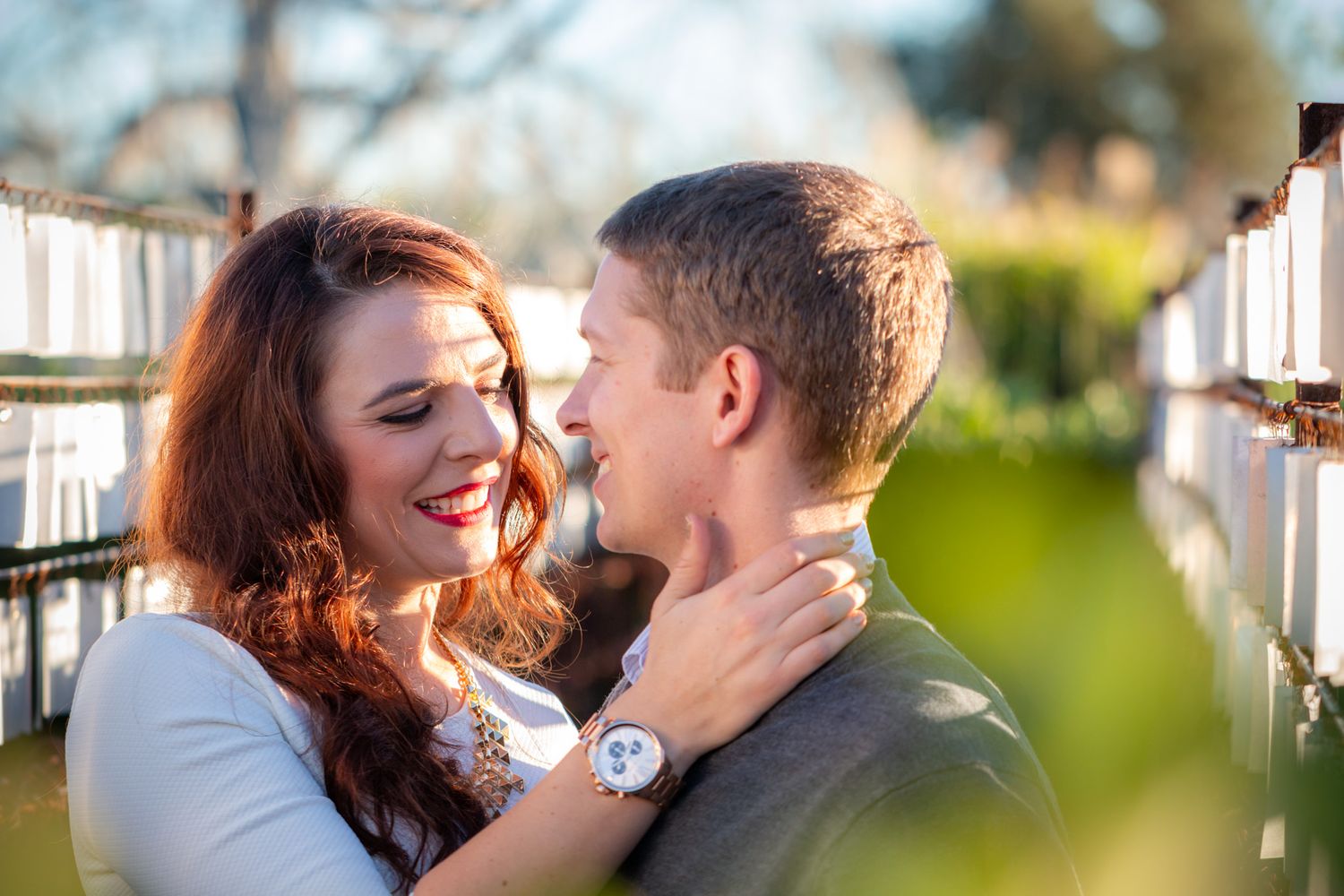 Intimate close-up of couple sharing tender moment outdoors with natural lighting.