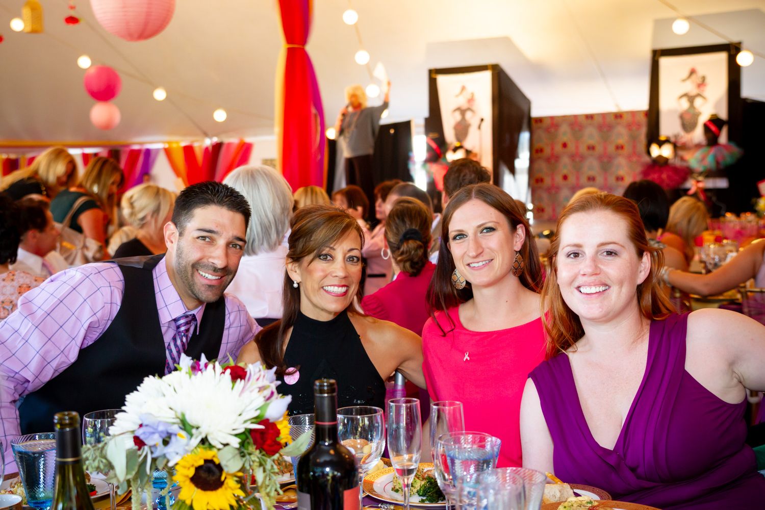 Wedding reception table decorated with sunflowers and festive party atmosphere.