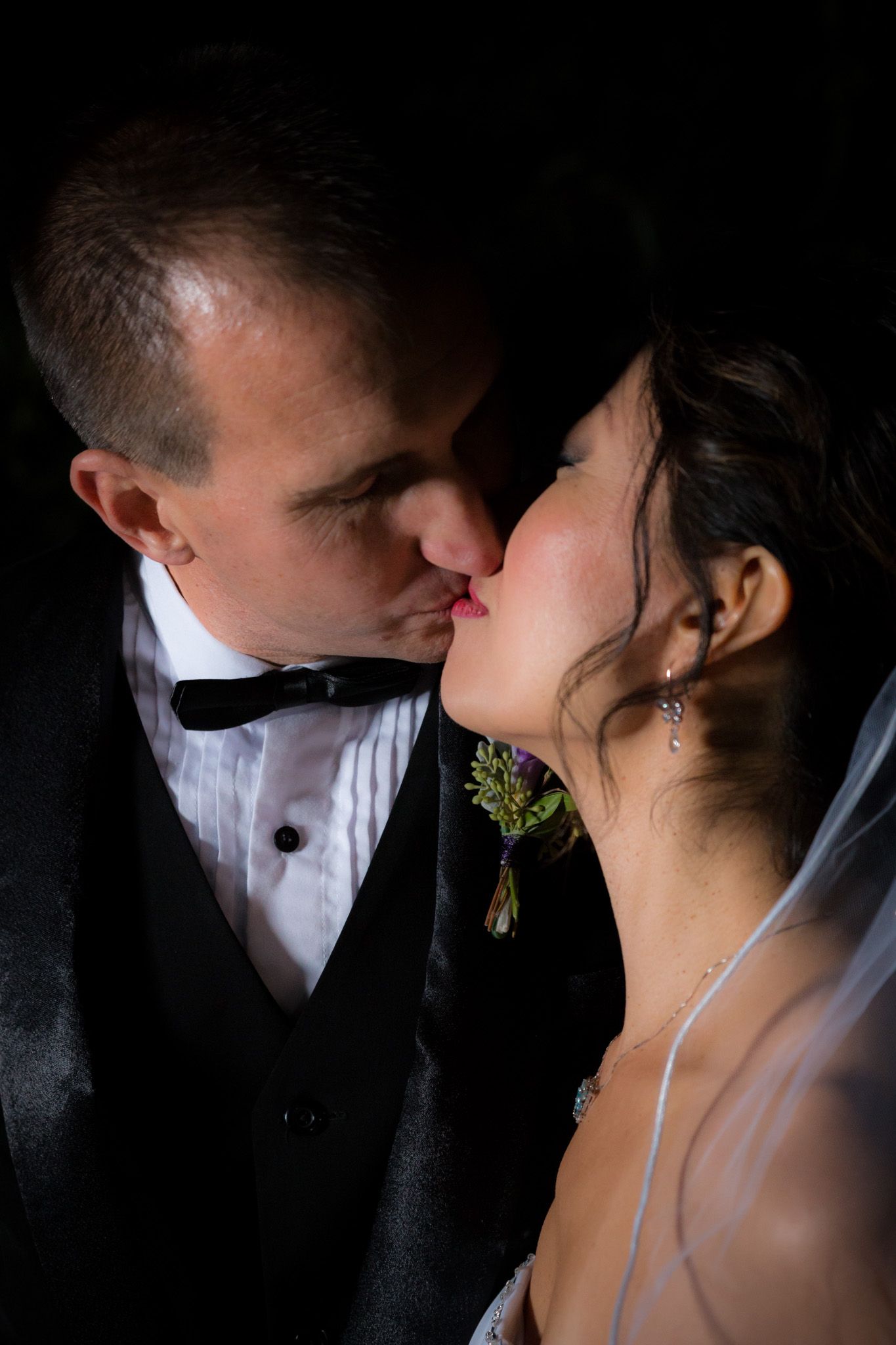 A series of romantic wedding photos showing close-up silhouettes of a couple sharing intimate kisses against dark backgrounds.
