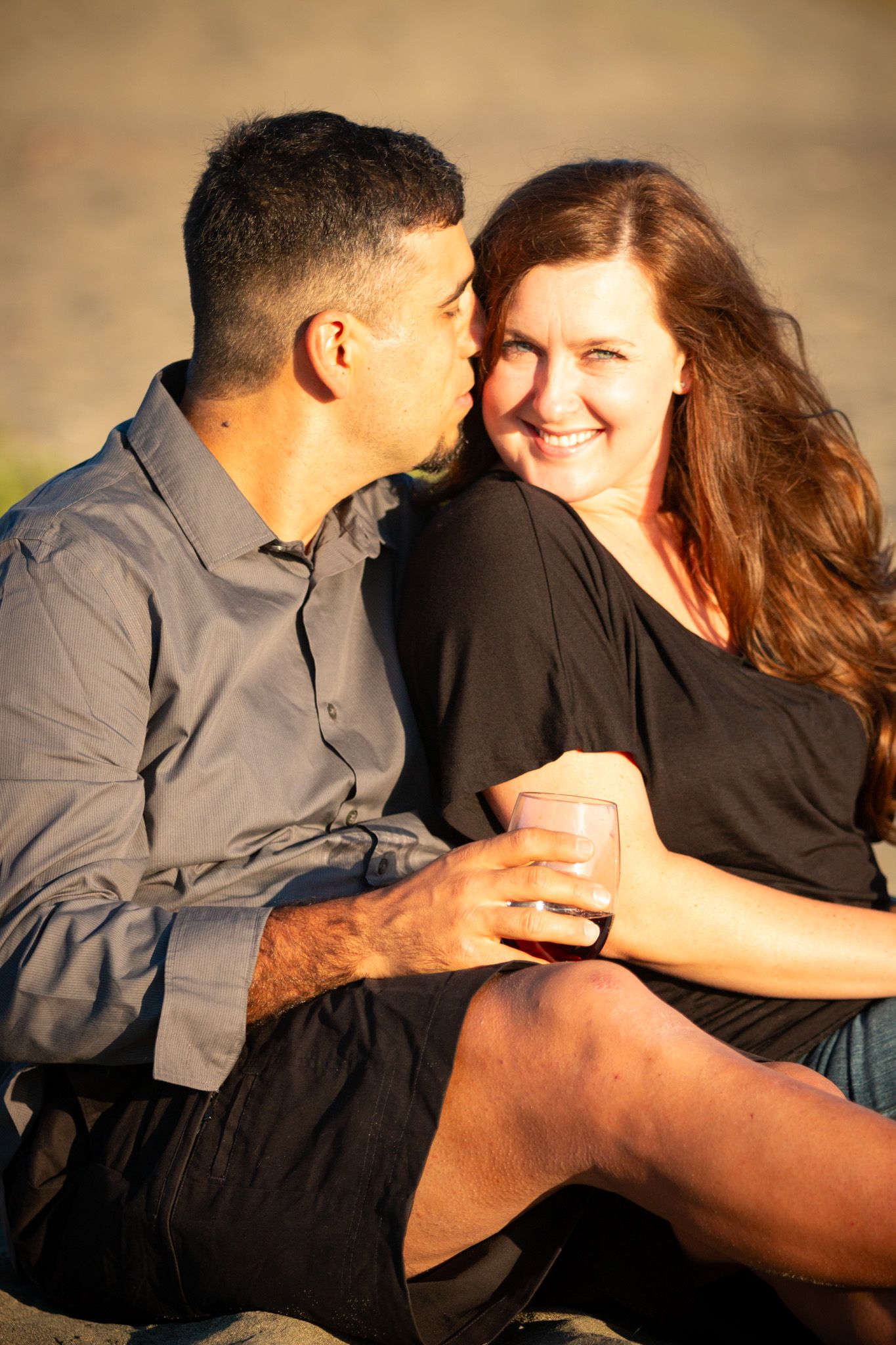 Intimate portrait of couple sharing tender moment in warm sunset light.