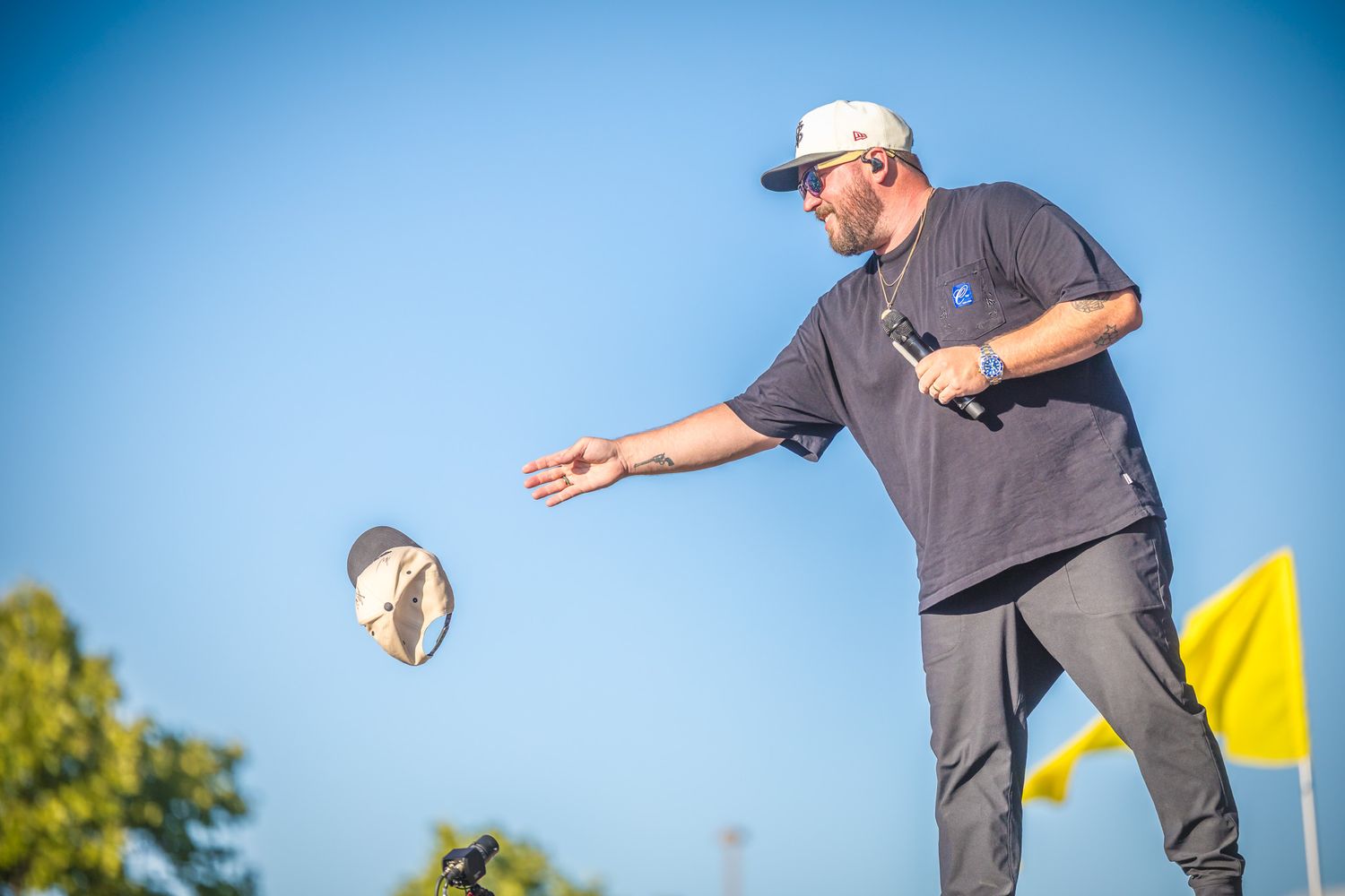 A series of frisbee ultimate players compete in an outdoor tournament during a bright sunny day.