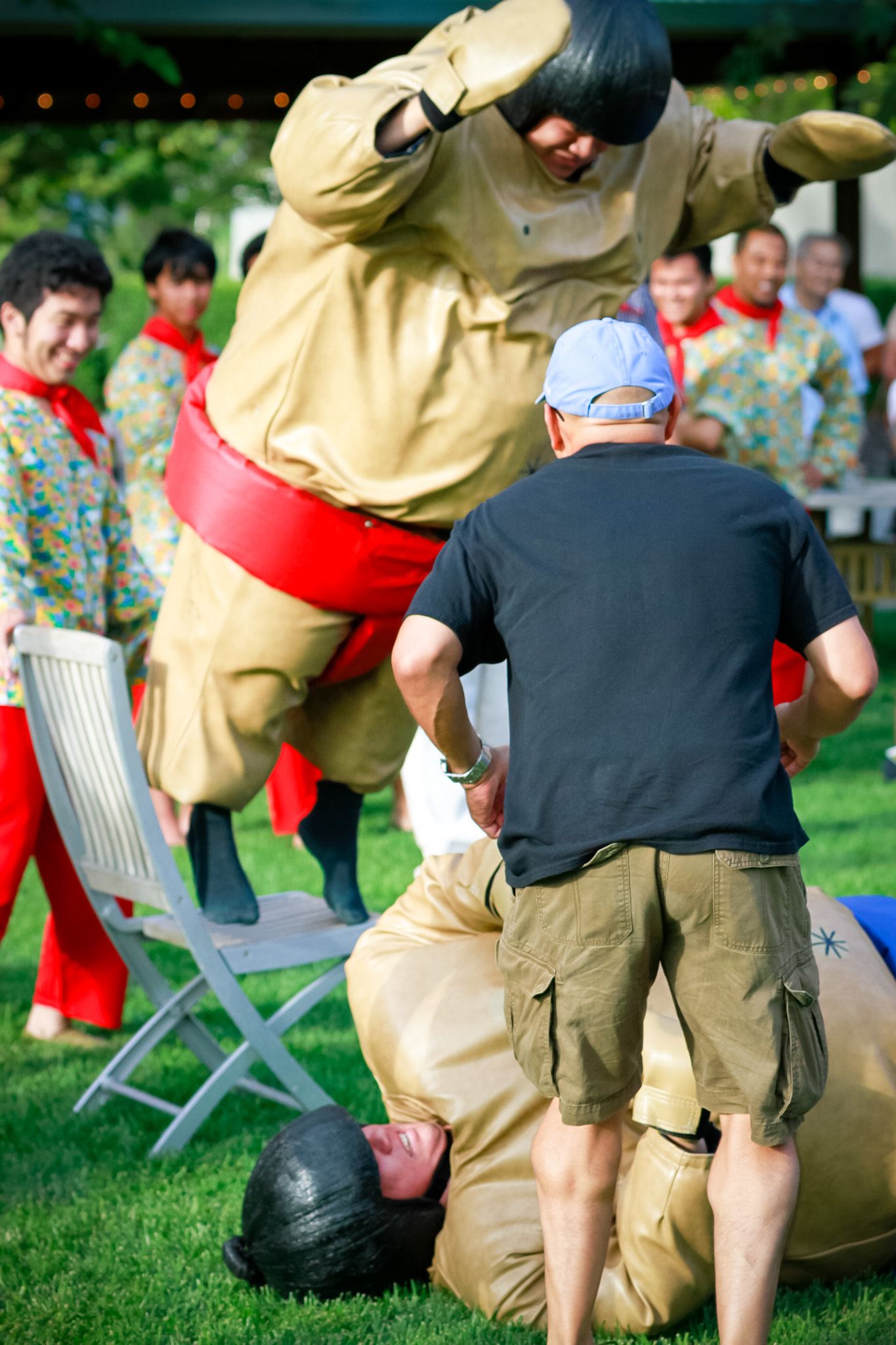 People in sumo suits participating in outdoor entertainment event.