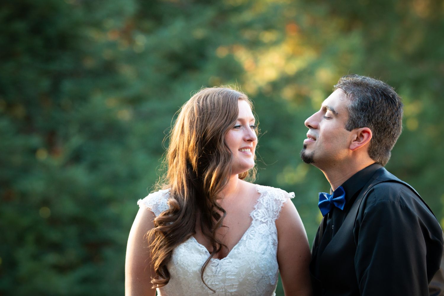 Couple shares romantic moment during outdoor wedding ceremony.
