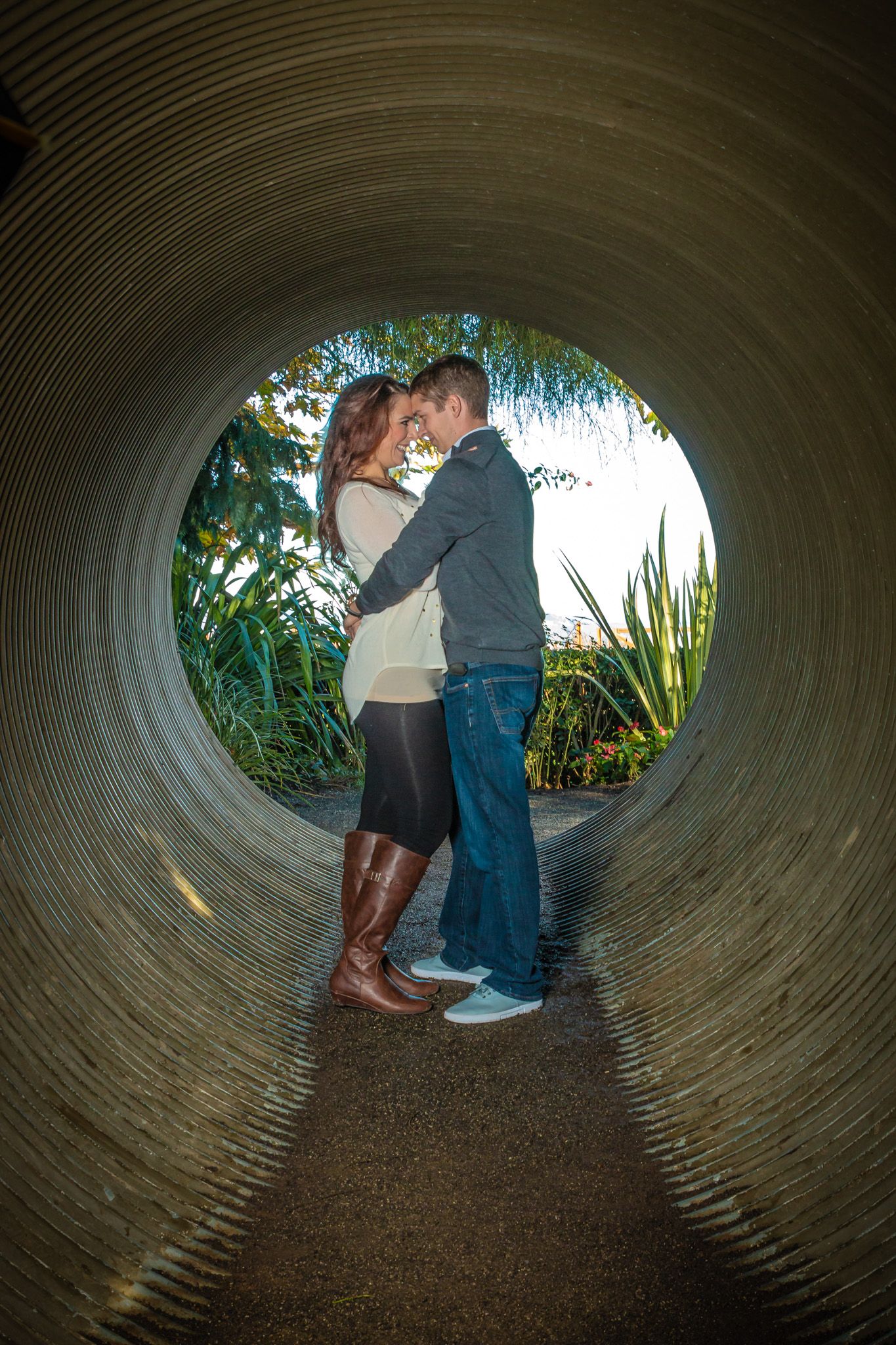Series of photos inside a large concrete tunnel, showing a couple in silhouette against a nature backdrop at the tunnel's end.