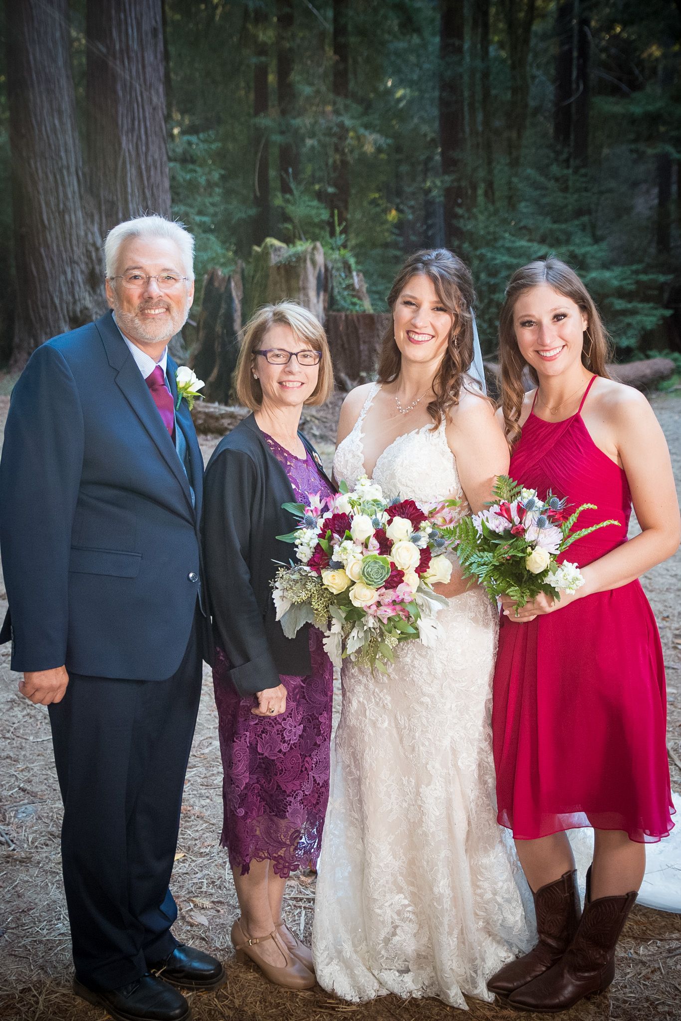 Wedding party group photo with bride in white dress and family members in coordinated formal attire.