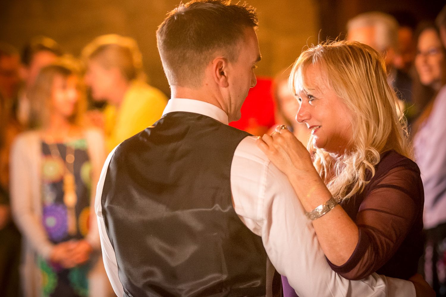 Tender moment during mother-son dance at wedding reception.