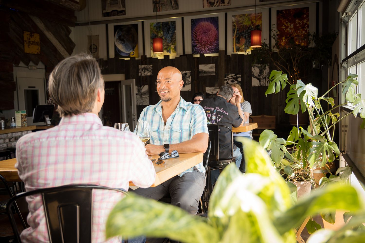 Interior of wine tasting room with conversations and ambient lighting.
