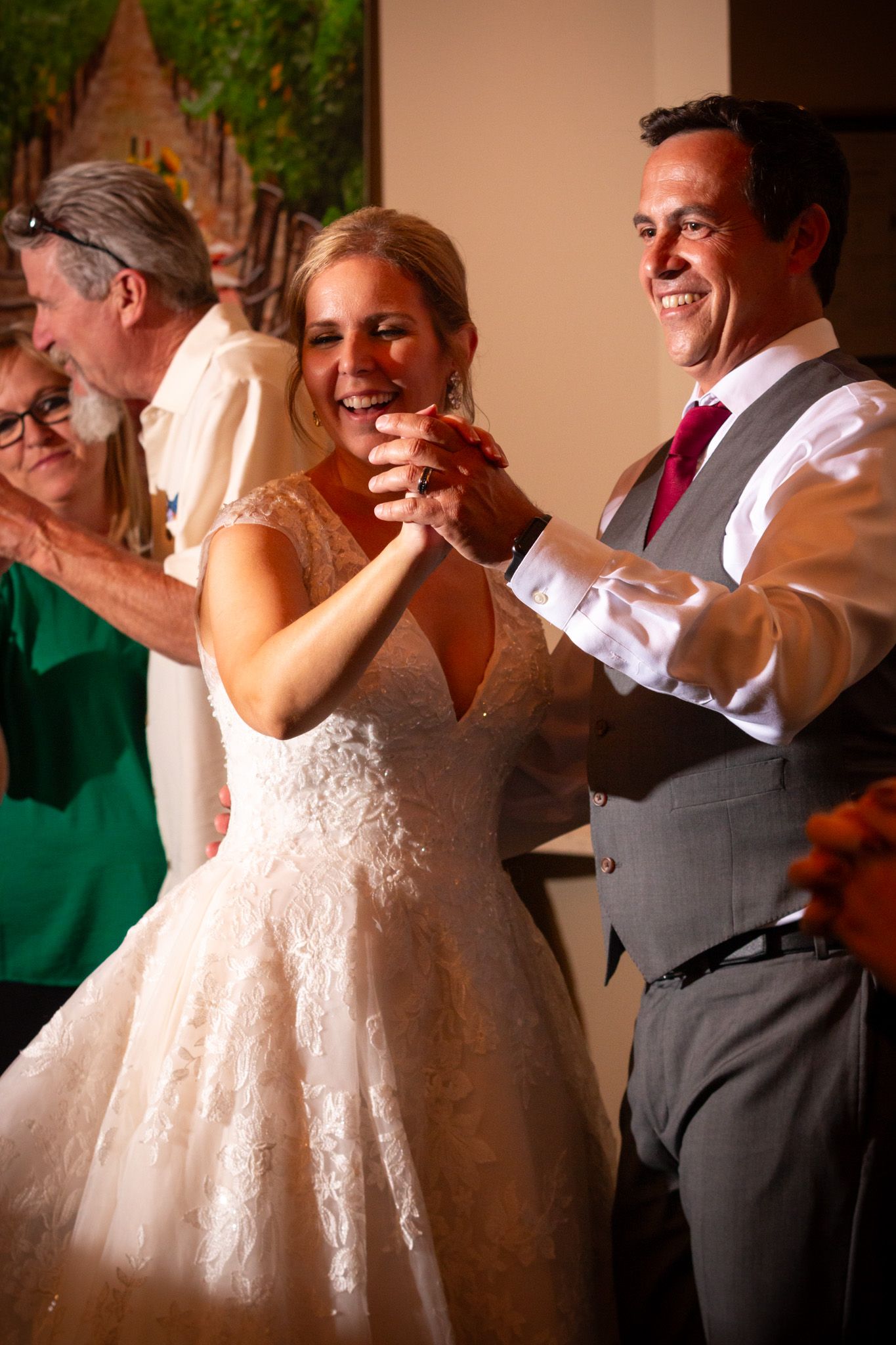Dancing and celebration during wedding reception with guests in formal attire.