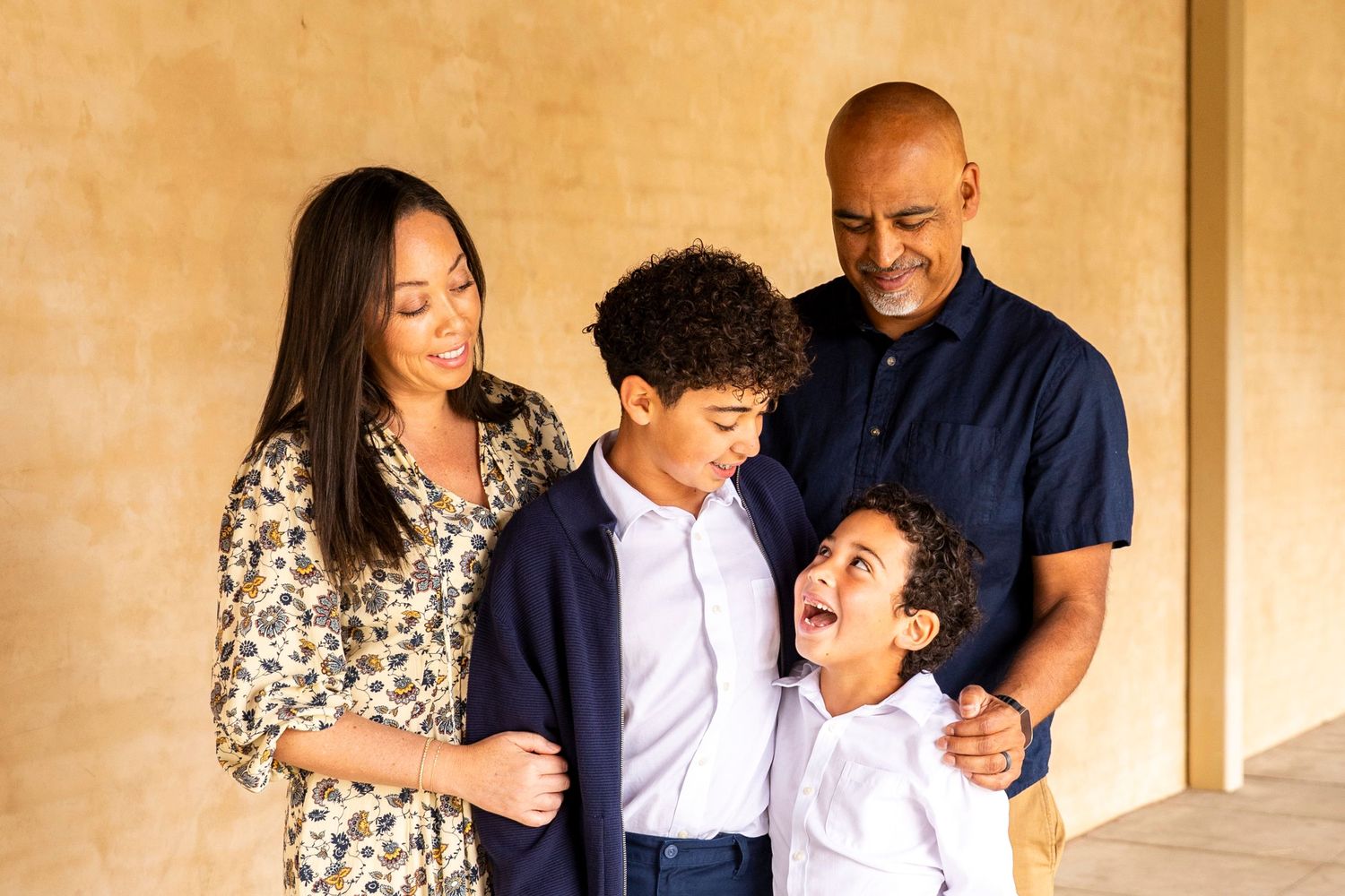 A collage of family photos showing joyful candid moments together against a beige backdrop.