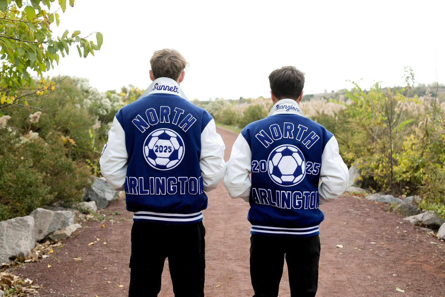 Back view of two varsity jackets showing 'North Arlington' soccer team lettering.