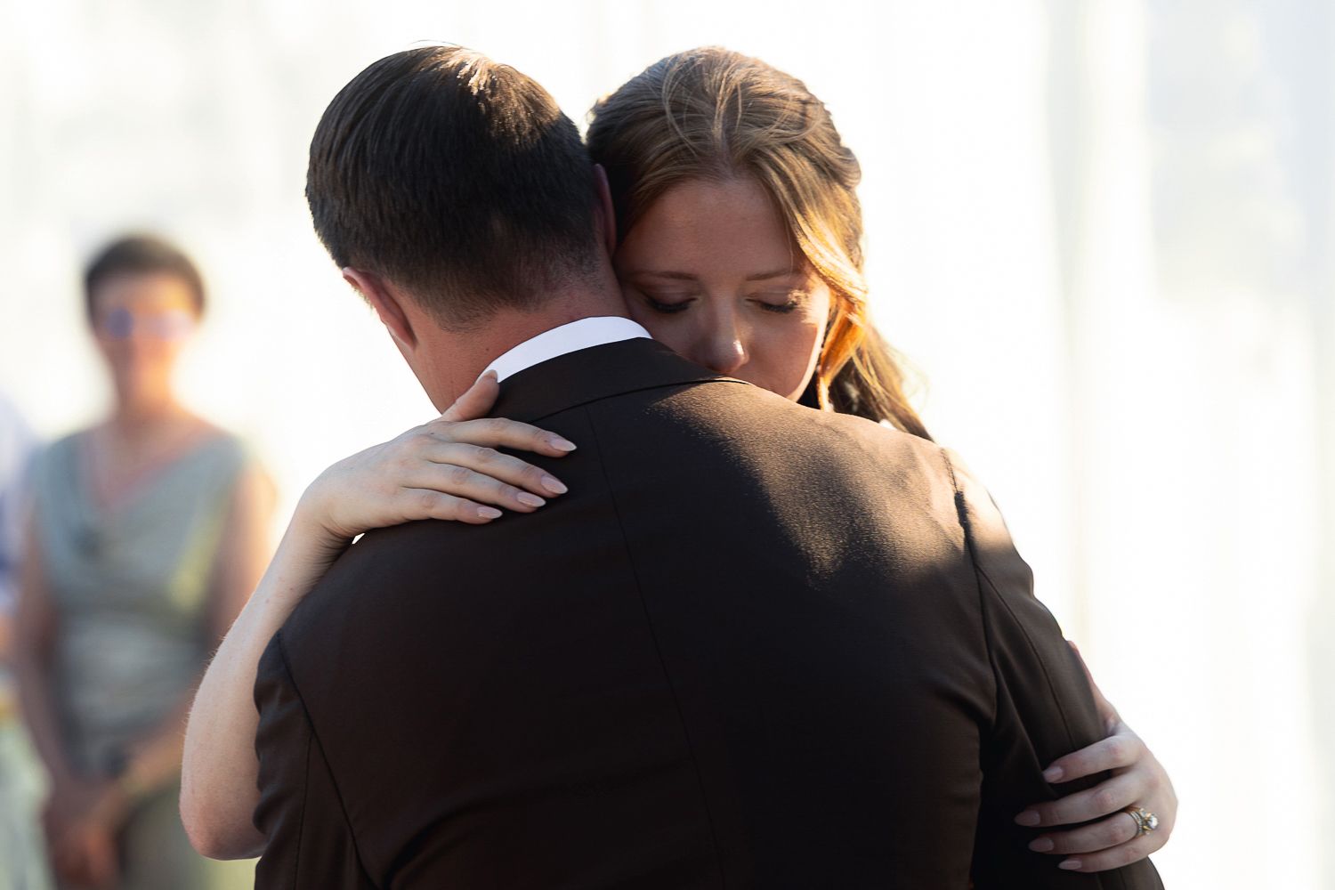 Emotional embraces and hugs shared between guests during special event.