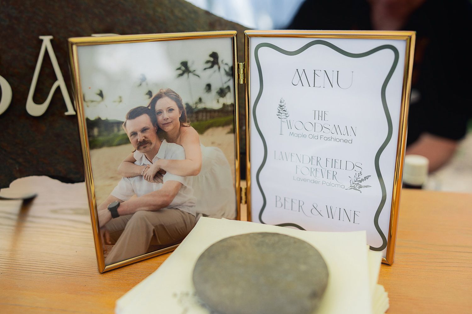 Wedding decor featuring a framed photo and menu display on a table setting.