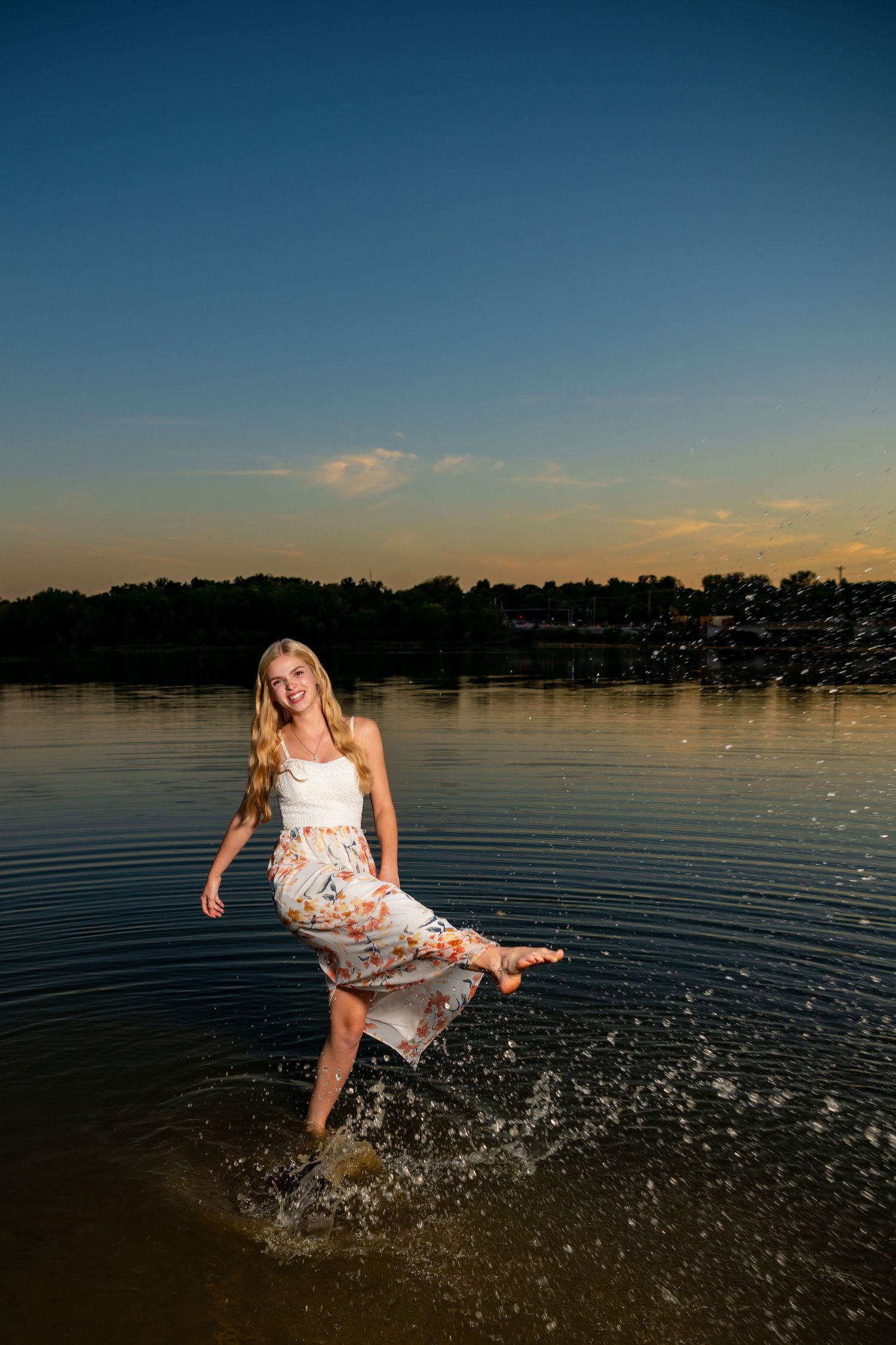 Omaha Senior Photography - Photographer in Omaha - Sunset lakeside photo splash with flowing dress in summer evening light.