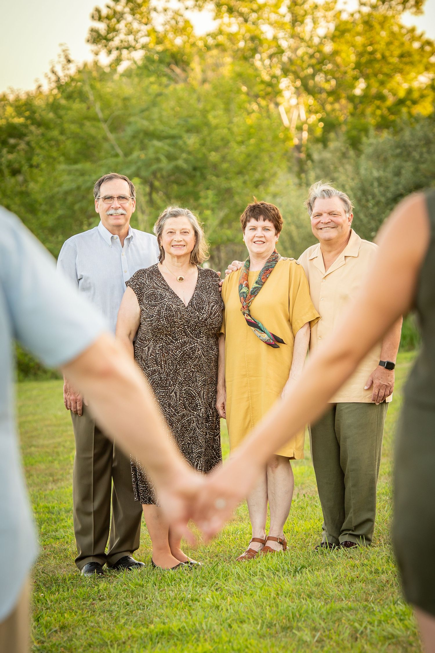 Chalco Lake - A unique family photo perspective showing people in the background through a heart shape made by hands in the foreground.