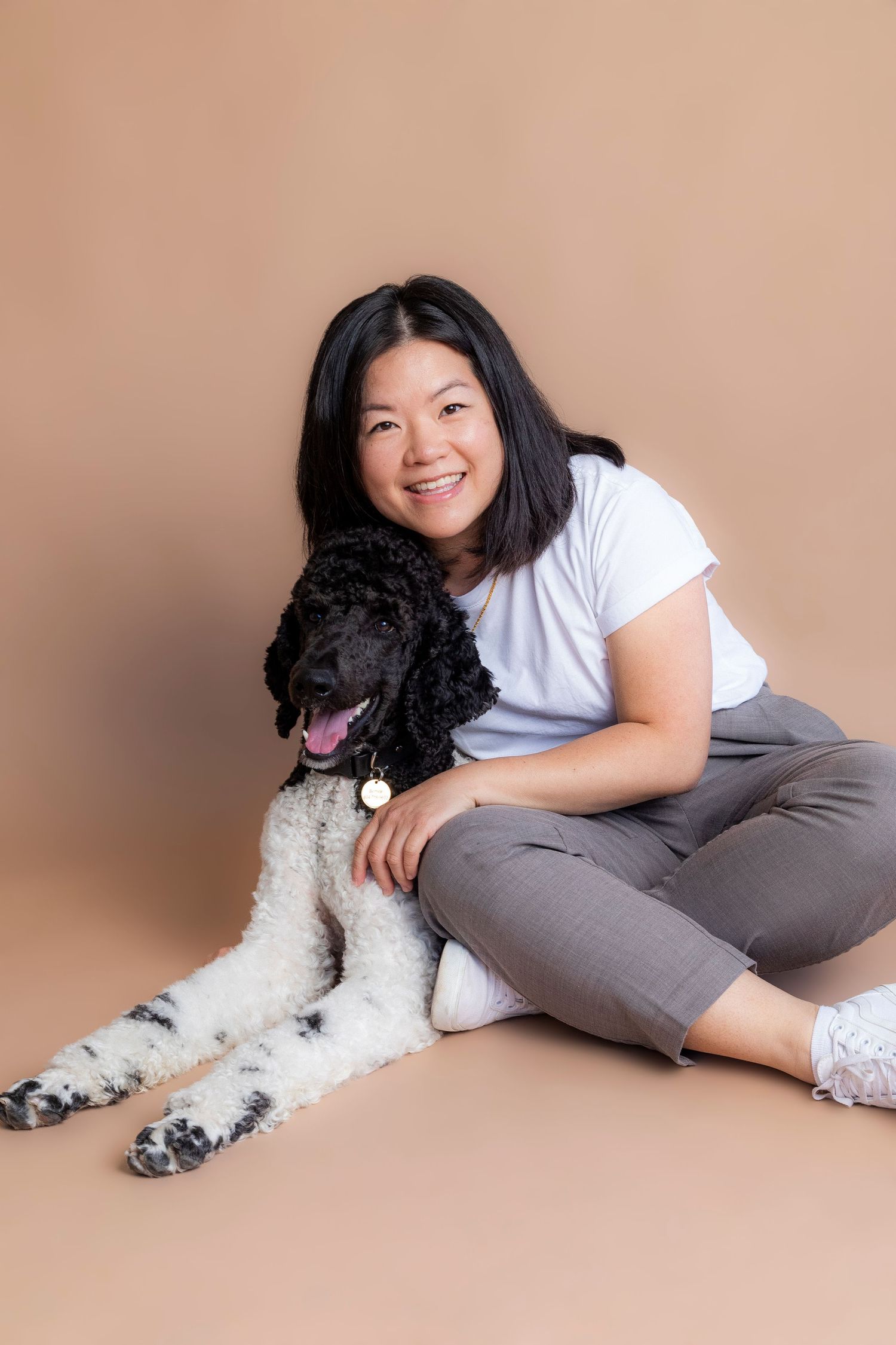 Black and white doodle dog posing with companion in studio setting. Taken by Dog Photographer in Vancouver, British Columbia.