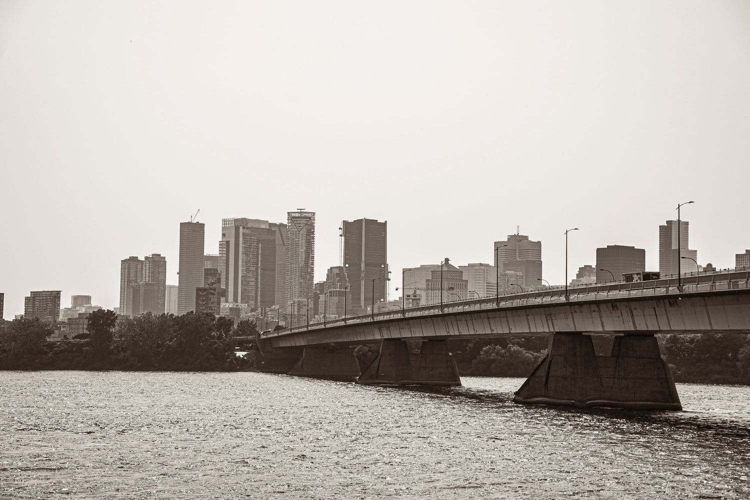 A black and white cityscape of Boston's downtown skyline with Longfellow Bridge spanning the Charles River.