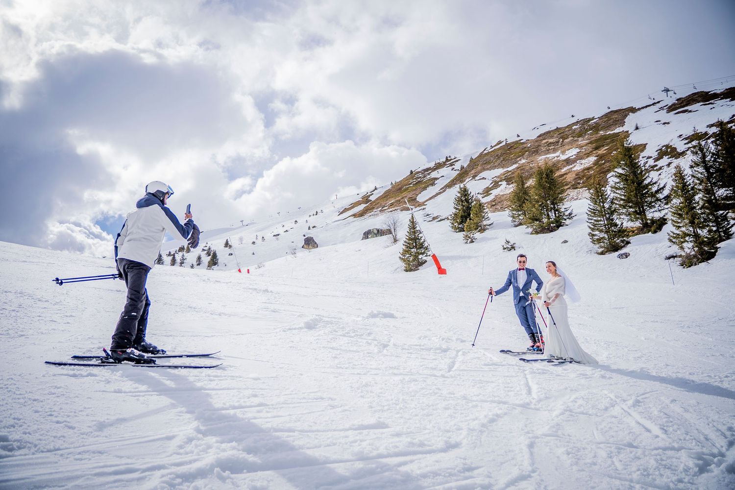 A sequence of skiers falling in deep powder snow shows multiple wipeout moments on a snowy mountain slope.