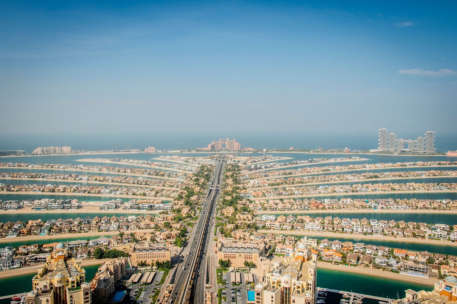Aerial panoramic view of Palm Jumeirah, Dubai's iconic man-made island with luxury villas and beachfront properties.