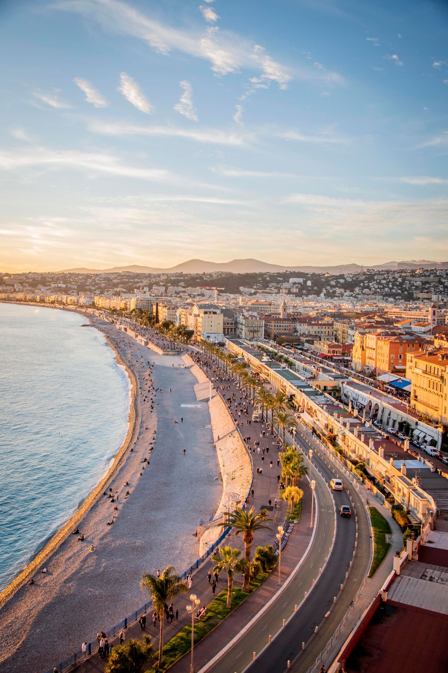 Aerial panoramic view of Nice's famous Promenade des Anglais and Mediterranean coastline during sunset.