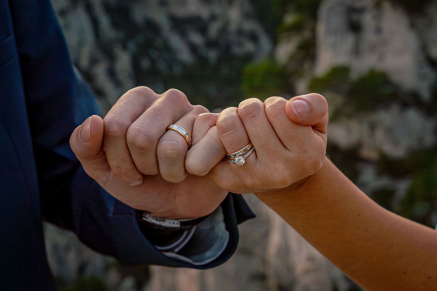 Close-up photos of hands with wedding rings show tender moments during a wedding ceremony celebration.