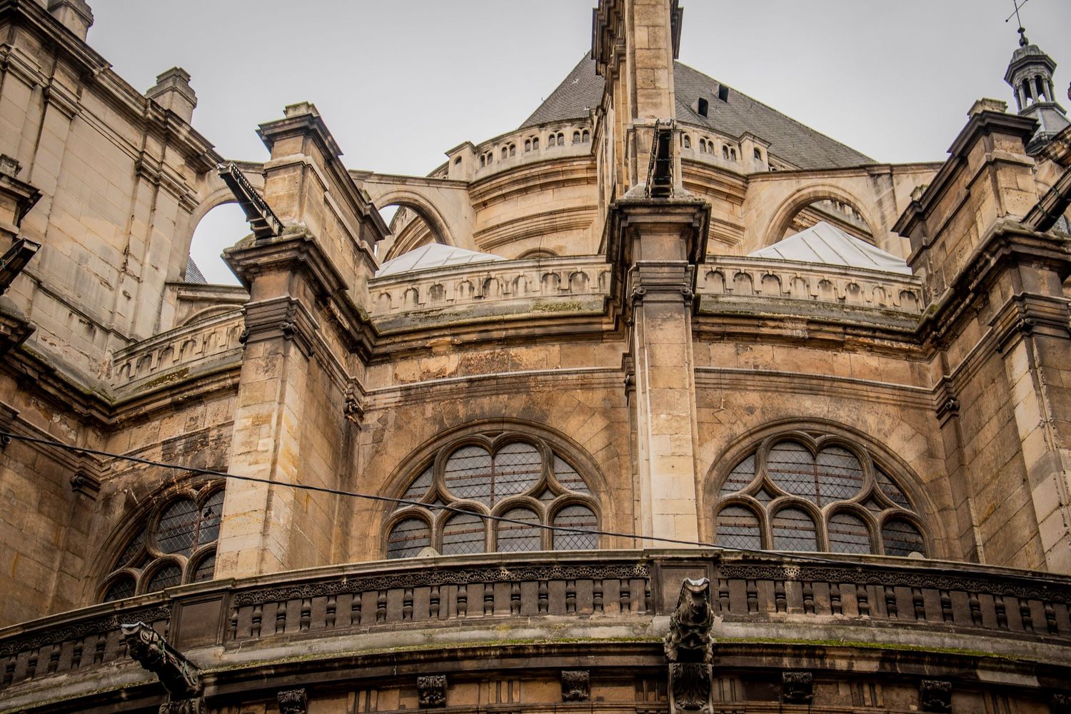 Ornate gothic cathedral architecture with stone carvings and arched windows along the exterior wall.