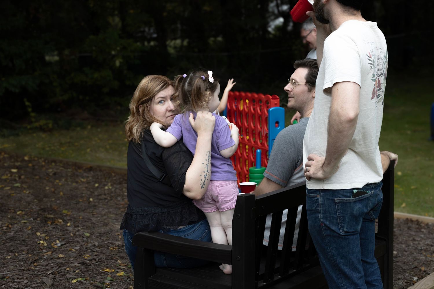 Several snapshots show intimate family moments together outdoors in a wooded park setting.