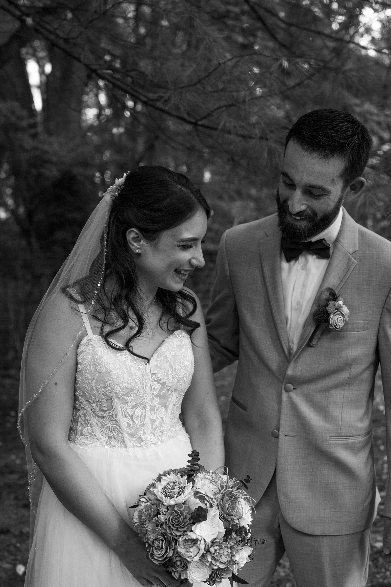 A wedding couple shares candid moments in a sequence of five black and white photographs taken outdoors.