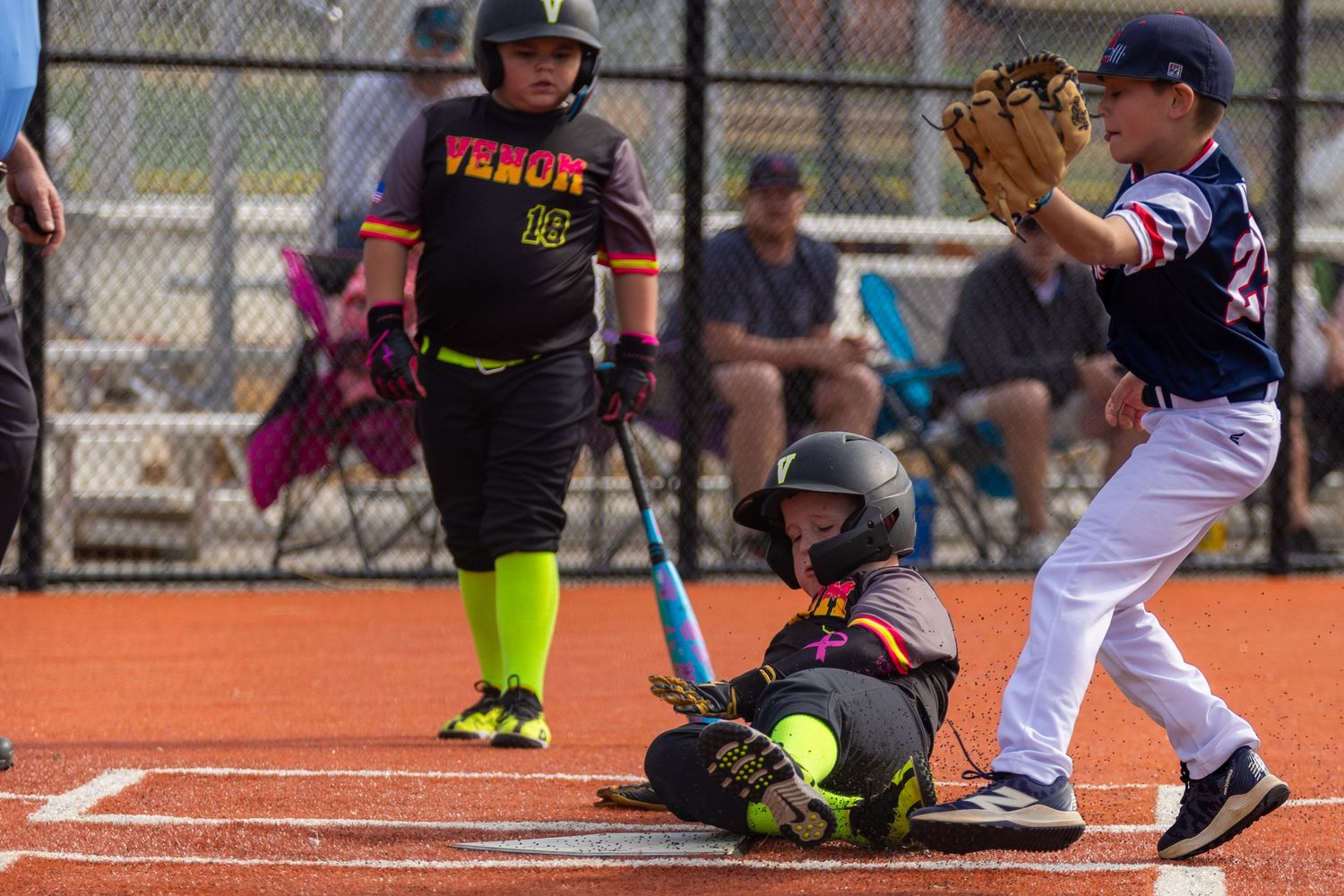 Baseball player sliding into home