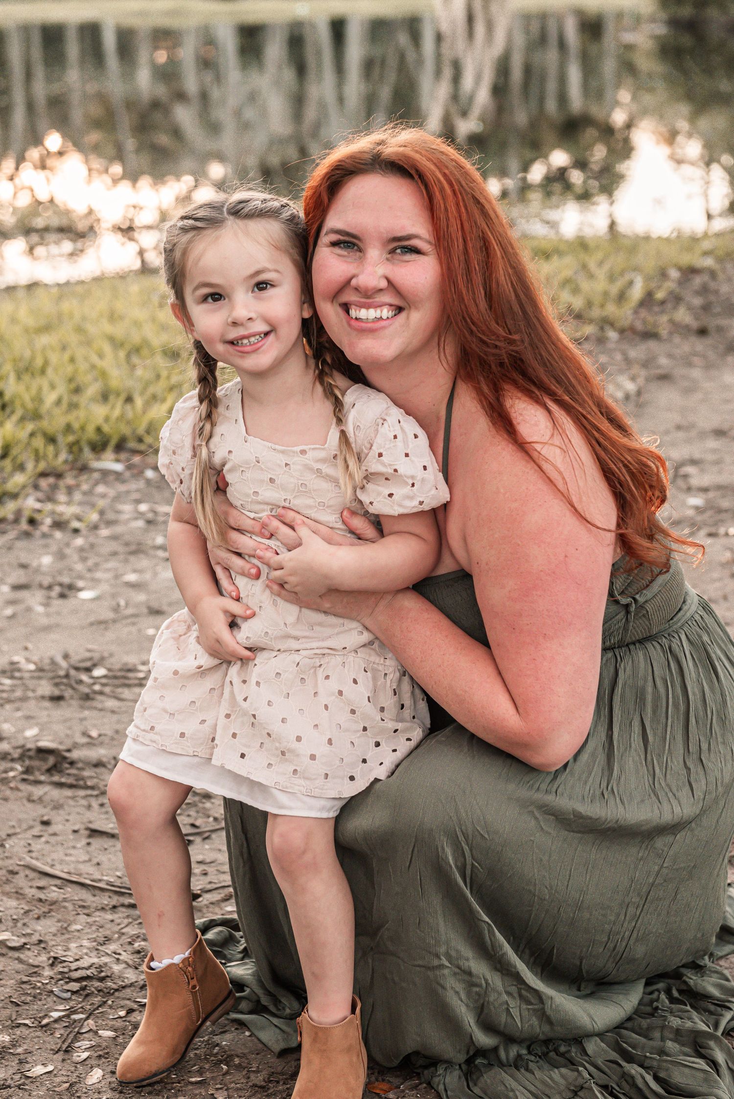 A warm outdoor portrait showing embracing figures in casual attire against a natural background.
