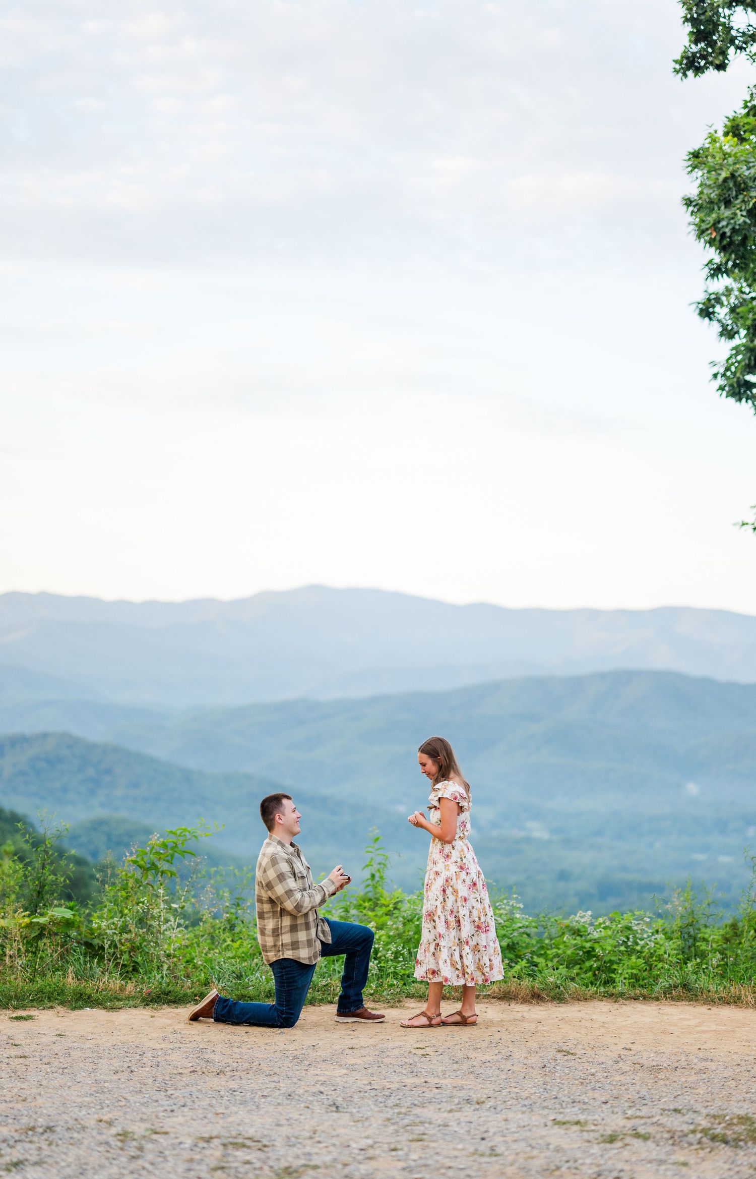 A scenic mountain proposal unfolds on a dirt overlook as the Blue Ridge Mountains create a stunning backdrop.