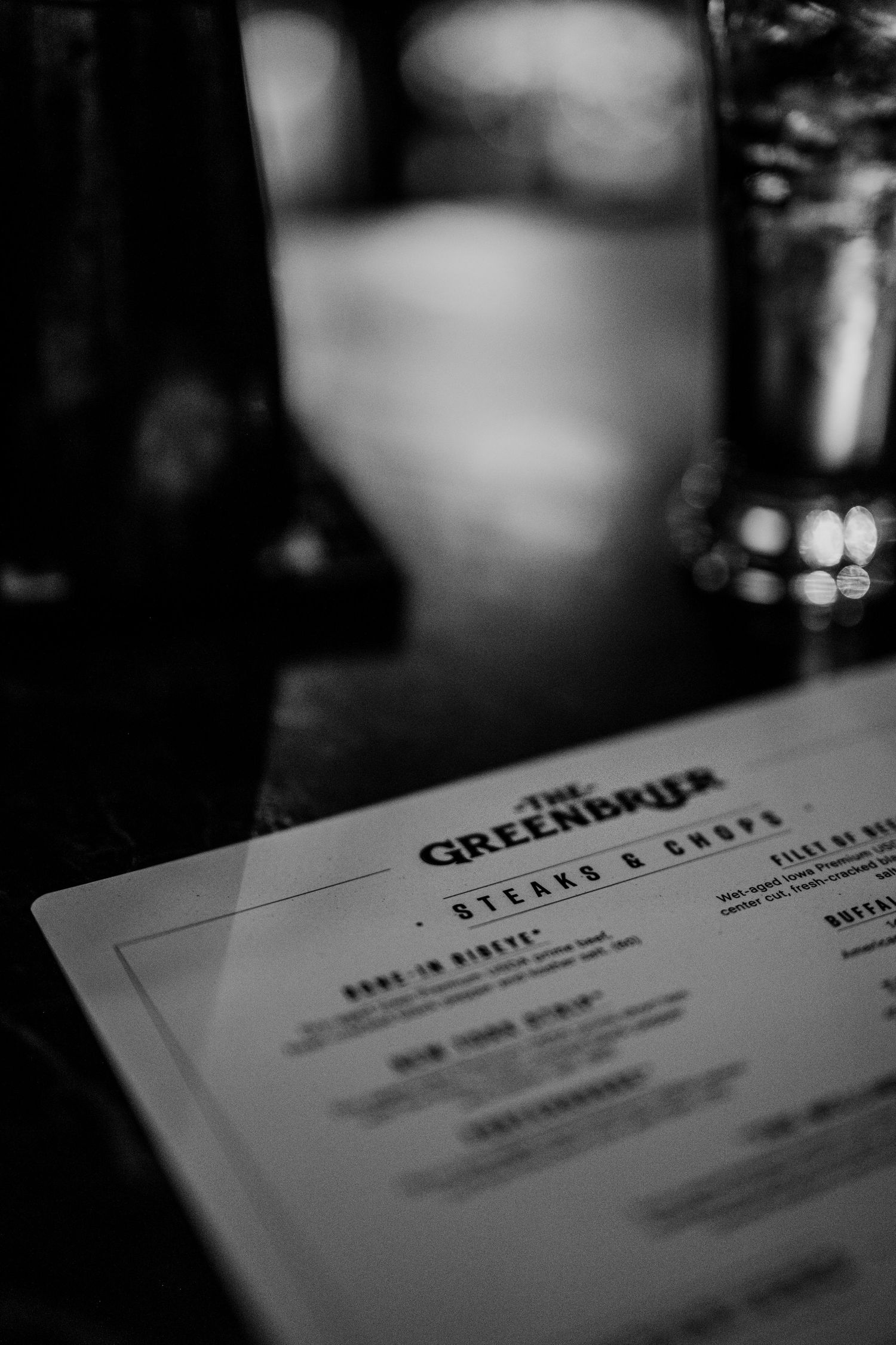 Black and white close-up shot of a restaurant menu from